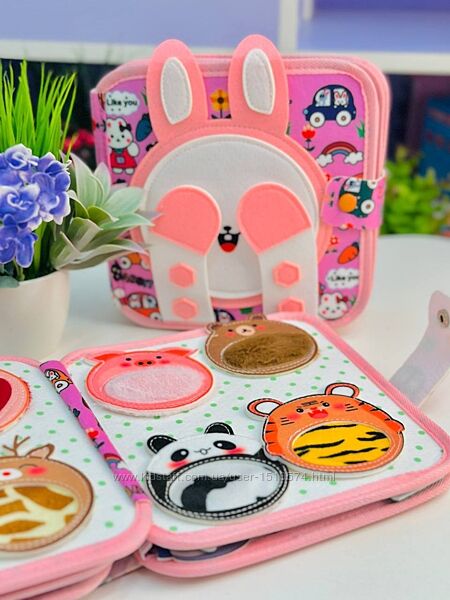 Bunny-themed Montessori busy book for toddlers with zippers, buttons and dressing activities.
