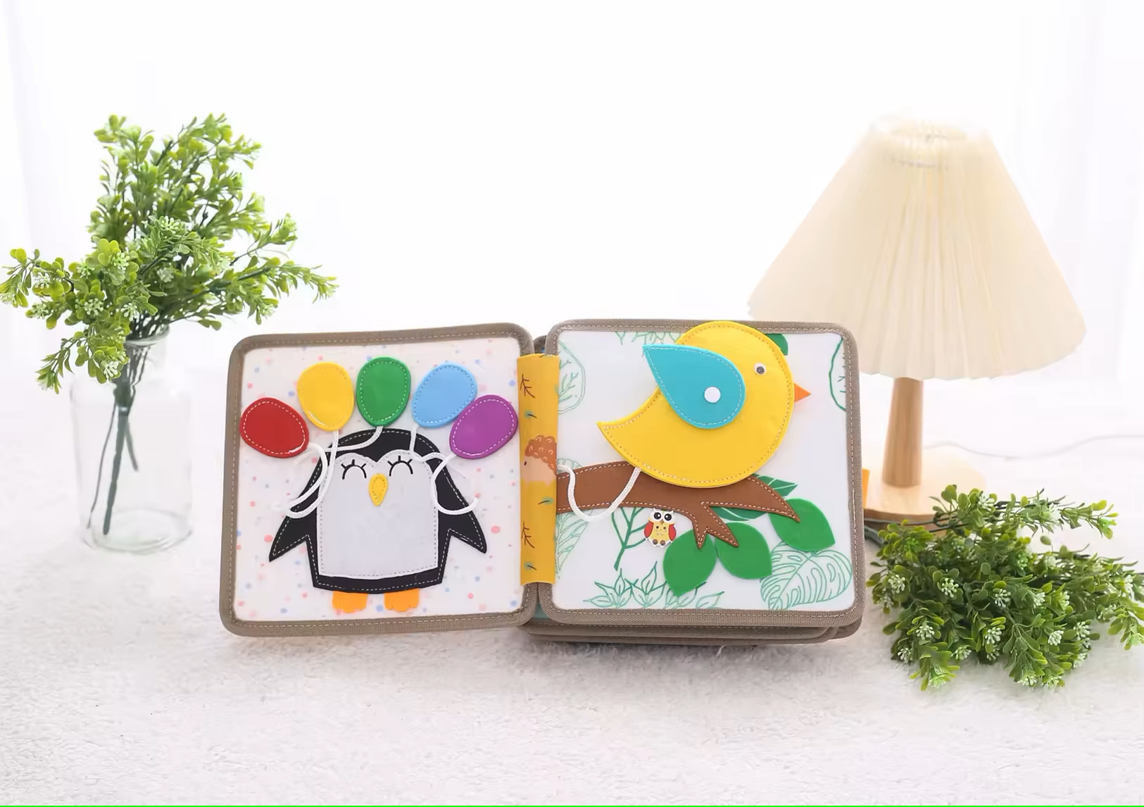 Interior pages of soft cloth busy book showing shape and color matching activities
