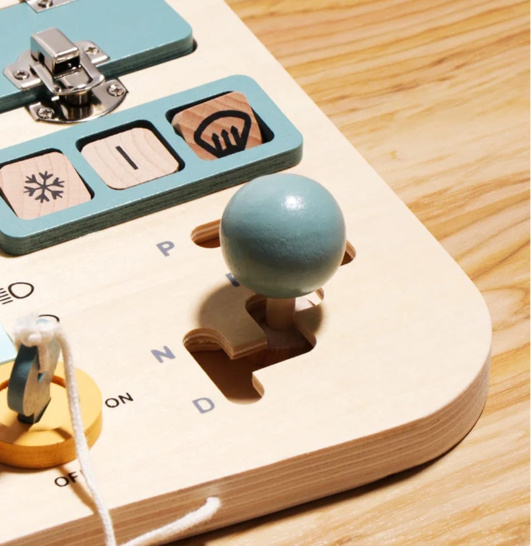 Wooden ignition key and dashboard controls on the busy board