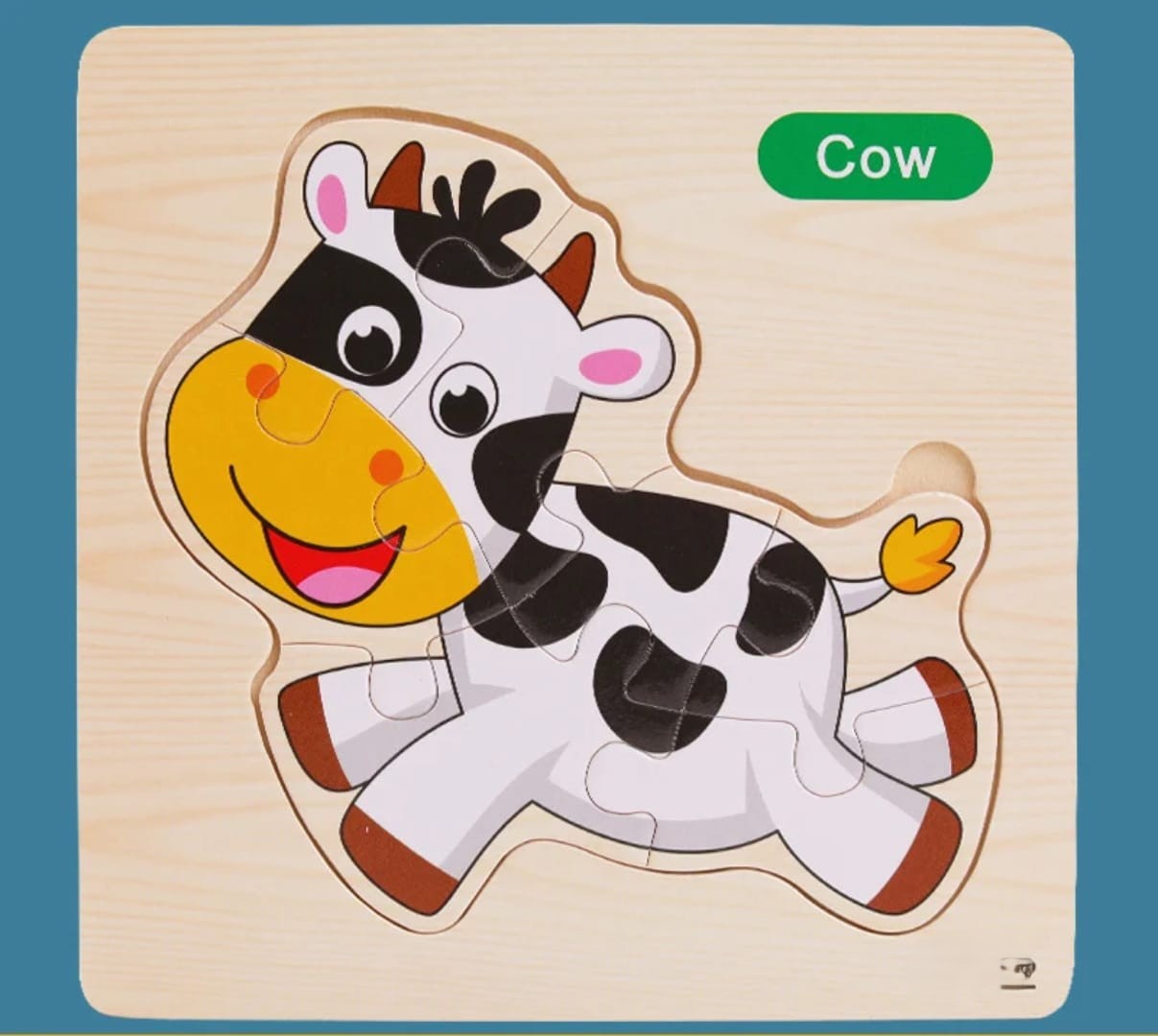 Wooden cow puzzle with colorful design on a blue background