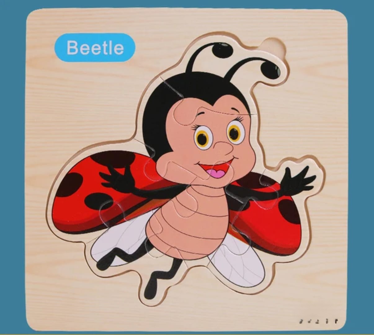 Wooden puzzle of a ladybug with 'Beetle' label on a blue background