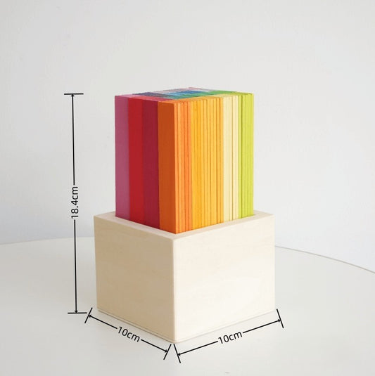 Colorful striped cube on a beige block with dimensions labeled